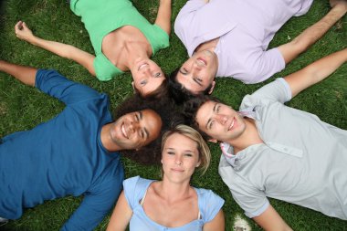 Group of friends laying down in park clipart