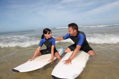 Father and daughter surfing clipart