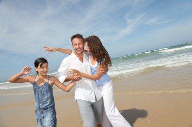 Family at the beach clipart