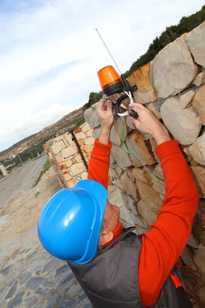 Worker installing gate system — Stock Photo, Image