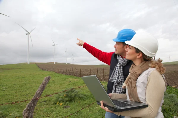 Ingenjörer som arbetar med vindkraft turbiner fält — Stockfoto