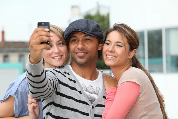 Grupo de amigos tomando fotos con teléfono móvil — Foto de Stock