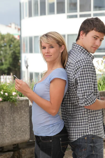 Young couple of students with mobile phone — Stock Photo, Image