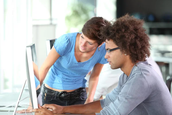 Young adults working on computer — Stock Photo, Image