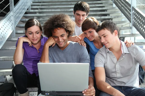 Grupo de estudantes universitários com computador portátil — Fotografia de Stock