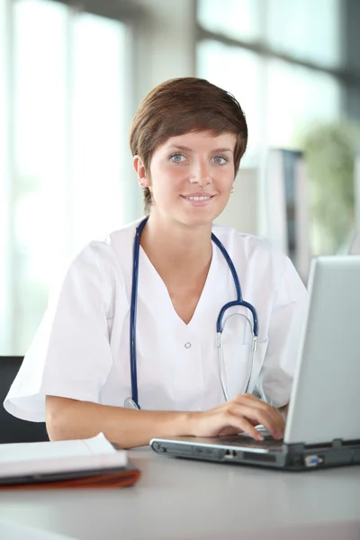 Hermosa enfermera delante de la computadora portátil —  Fotos de Stock