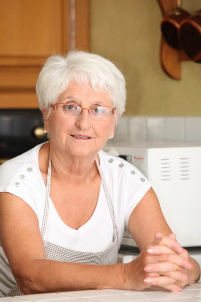 Elderly woman in kitchen — Stock Photo, Image