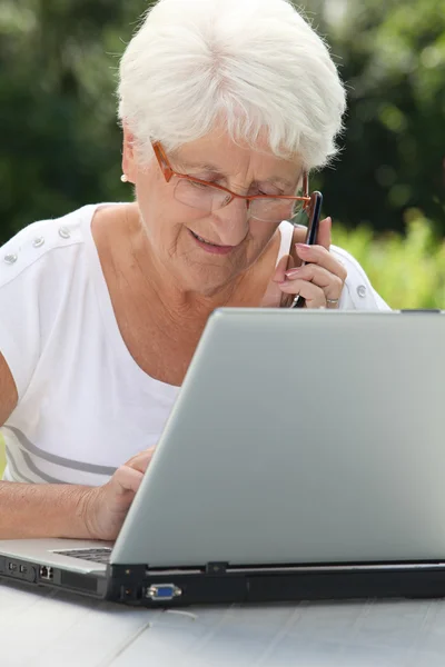 Mujer mayor usando internet — Foto de Stock