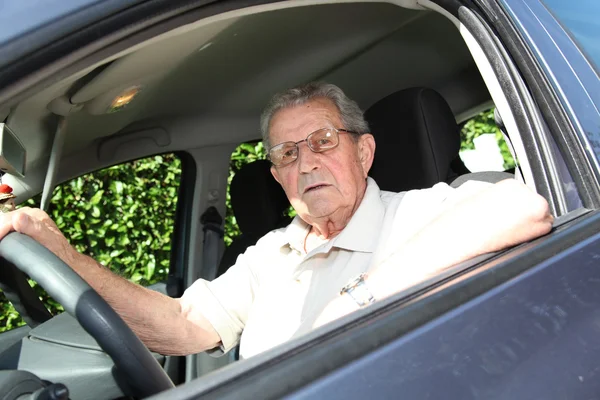 Elderly person driving a car — Stock Photo, Image