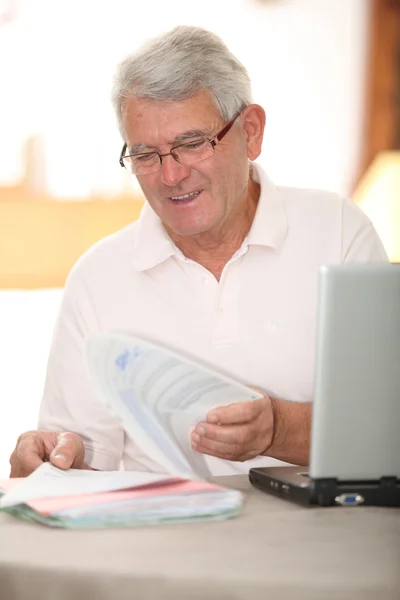 Старший чоловік робить податкову декларацію в Інтернеті — стокове фото