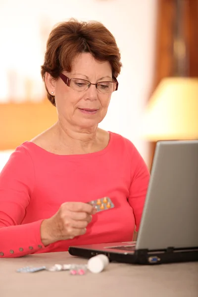 Mulher sênior procurando informações médicas na internet — Fotografia de Stock