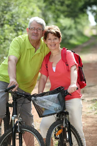 在农村中的高级夫妇骑自行车 — 图库照片