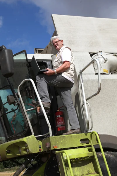 Mann klettert auf Erntemaschine — Stockfoto