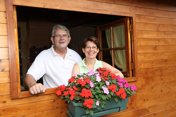 Senior couple in log cabin — Stock Photo, Image