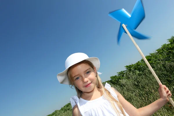Little girl with blue wind wheel — Stock Photo, Image