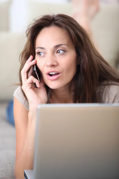 Woman with laptop computer and telephone — Stock Photo, Image