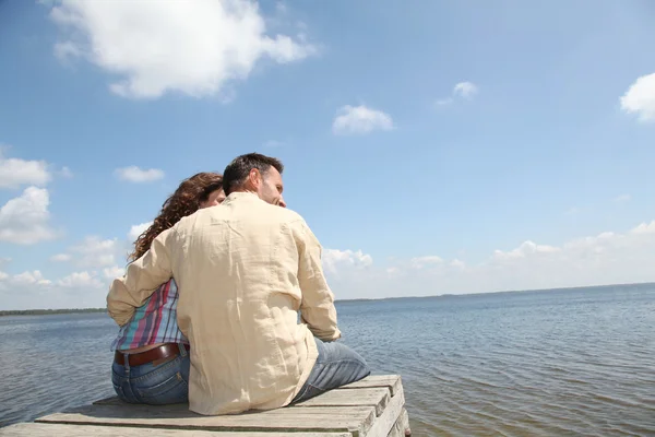 Couple relaxing on a pontoon — Stock Photo, Image