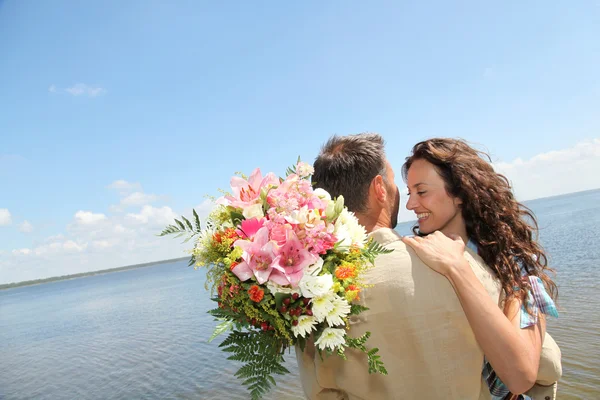 stock image Loving couple with bunch of flowers