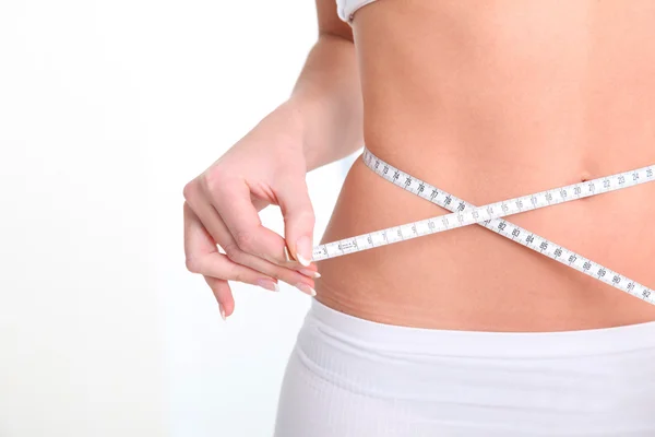 Slim woman's waist and measure tape — Stock Photo, Image