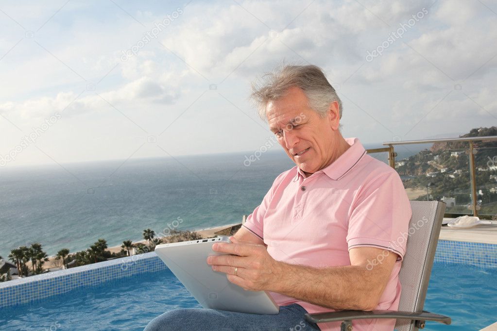Senior man using electronic tablet