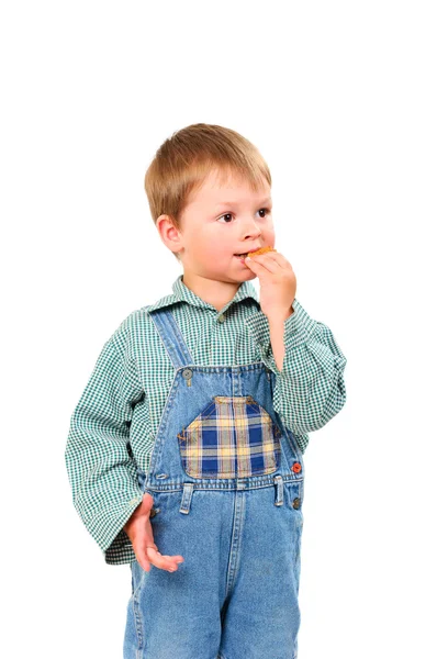 Mały chłopiec jedzenia ciasteczka — Zdjęcie stockowe
