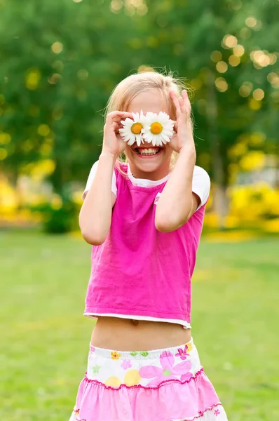 Счастливая маленькая девочка с маргаритками — стоковое фото