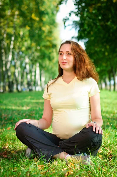 stock image Beautiful pregnant woman relaxing in the park