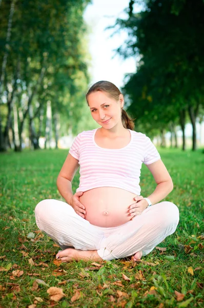 Hermosa mujer embarazada relajándose en el parque — Foto de Stock