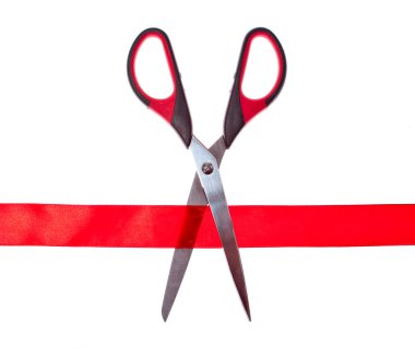 Scissors cutting through red ribbon or tape, isolated on white. clipart