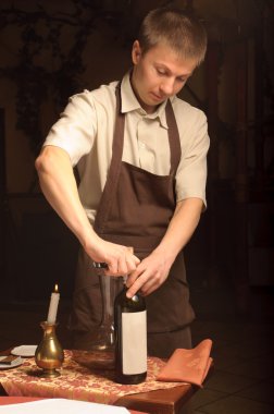 A sommelier opening wine bottle clipart