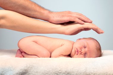 Newborn sleeping child on white blanket clipart