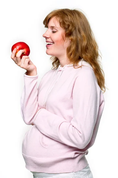 Mladá těhotná žena s červené jablko — Stock fotografie