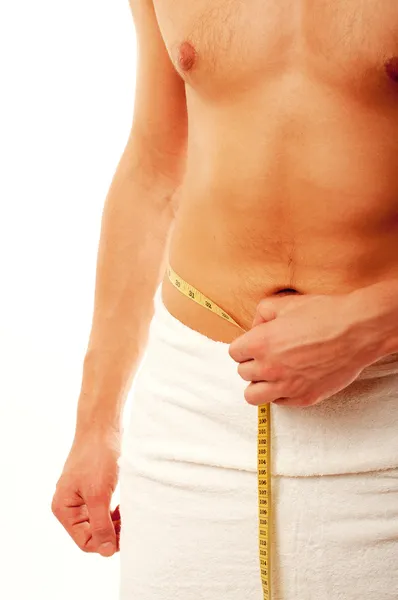 Young man measuring his waist — Stock Photo, Image