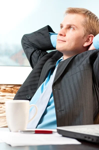 Retrato de um jovem empresário satisfeito descansando — Fotografia de Stock