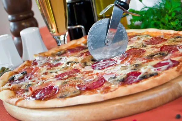 Närbild av en pizza med salami och svamp — Stockfoto