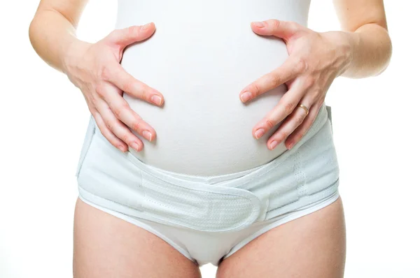 Close-up młodej kobiety w ciąży z gorset — Zdjęcie stockowe