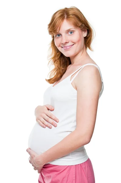Jonge zwangere vrouw die haar handen op haar buik — Stockfoto
