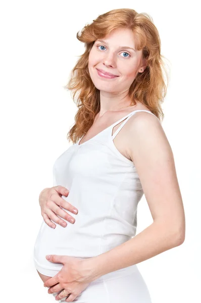 Νεαρή έγκυο, κρατώντας τα χέρια της την κοιλιά της — Φωτογραφία Αρχείου