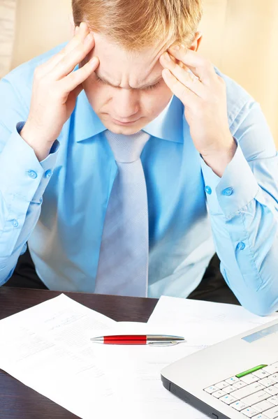 Portrait of a young businessman with headache Stock Photo