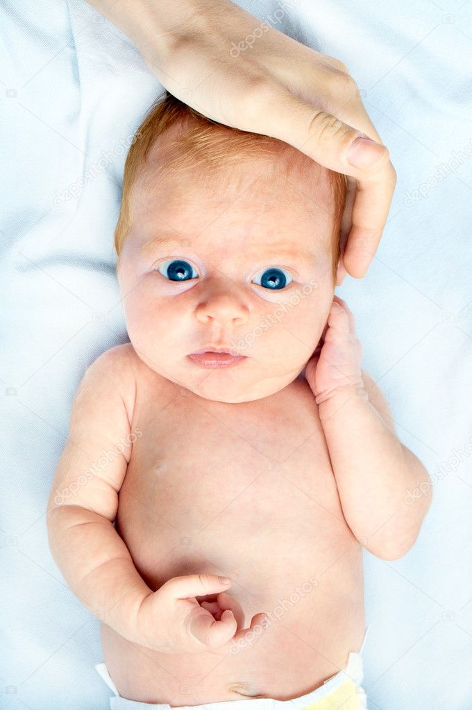 Cute newborn baby looking at camera