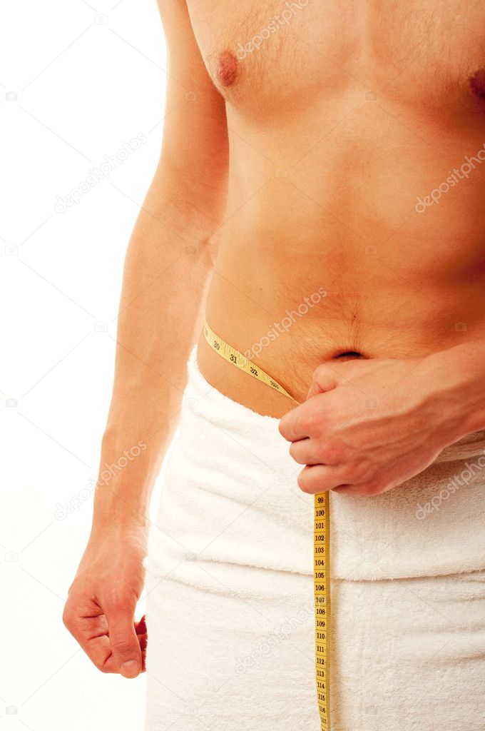 Young man measuring his waist