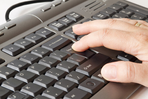 Hand pressing enter on keyboard
