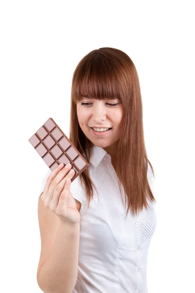 stock image A young woman is holding a bar of chocolate