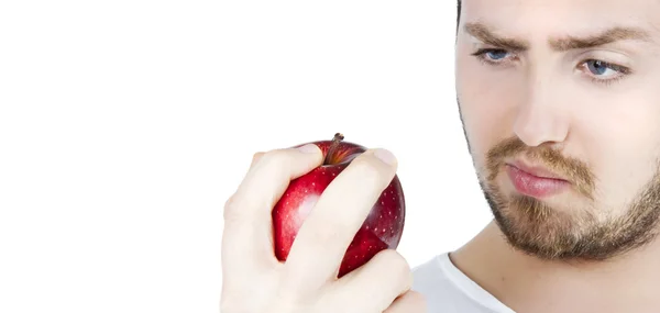 Młody człowiek jedzący jabłko — Zdjęcie stockowe