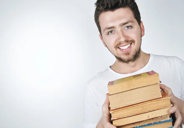 Young happy man carrying books