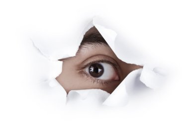 Eye Looking Through A Paper Hole clipart