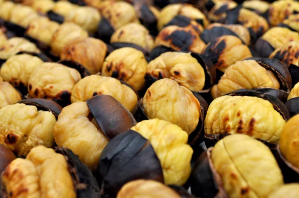 Delicious grilled chestnuts as background — Stock Photo, Image