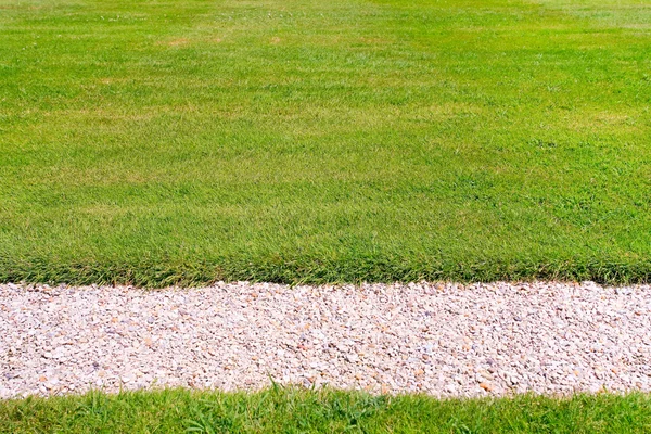 Stock image Green lawn and pebbles path