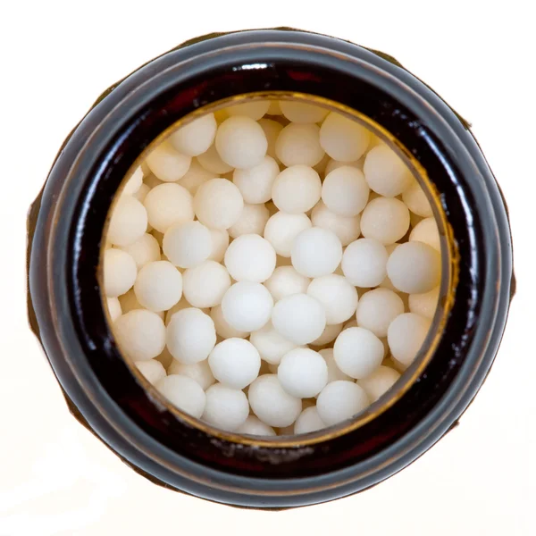 Flaskan med homeopati socker boll — Stockfoto