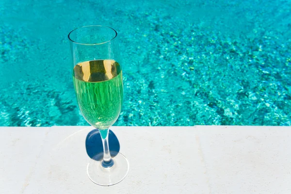 stock image Glass of white wine on pool board outdoor